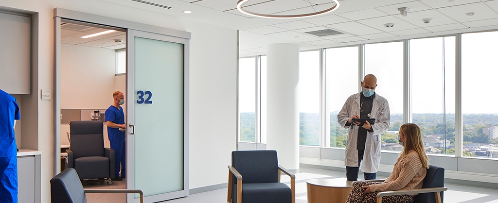 Spacious hospital waiting area with large sliding glass doors.