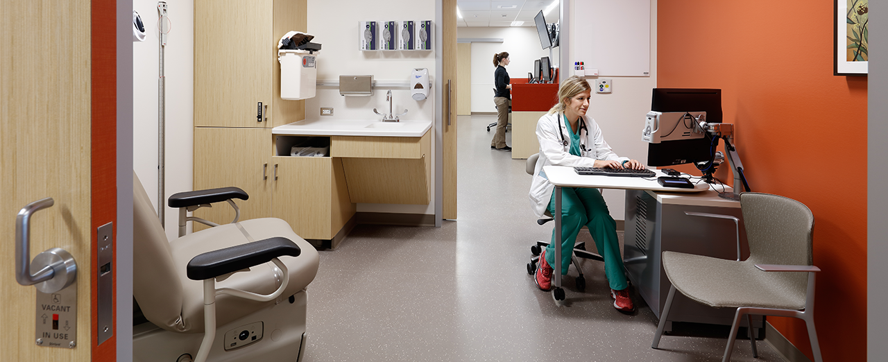 doctor working in exam room with open sliding doors