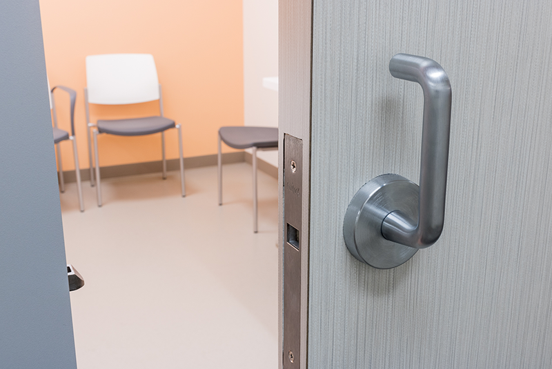 Lobby in a healthcare setting is partitioned by a fire-rated sliding door.