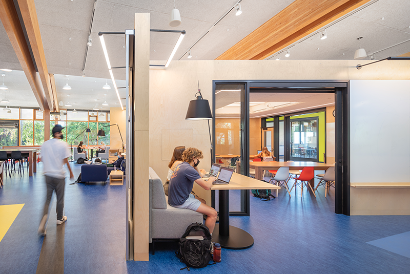 An open 7 ft wide sliding glass door shows a classroom full of students.