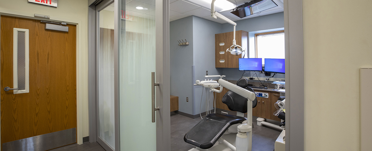 Dental clinic room with a sliding glass door.